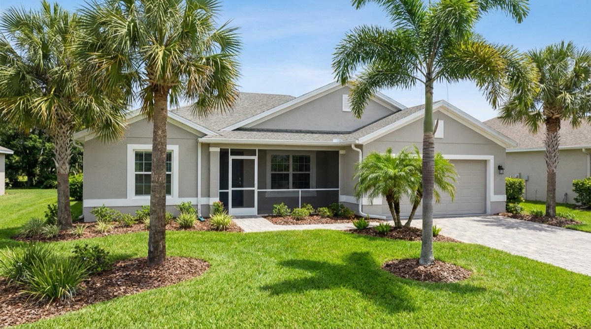Single-story Florida home with fresh gray exterior paint and white trim - JPL Painting exterior repaint